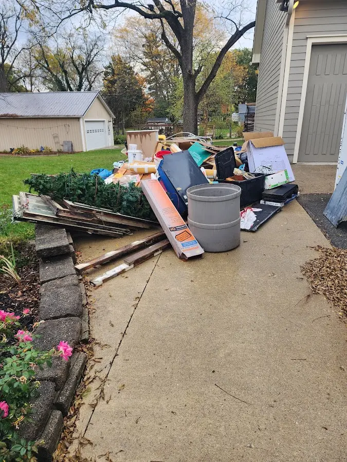Dumpster being loaded with debris for Commercial Dumpster Rental in South Point